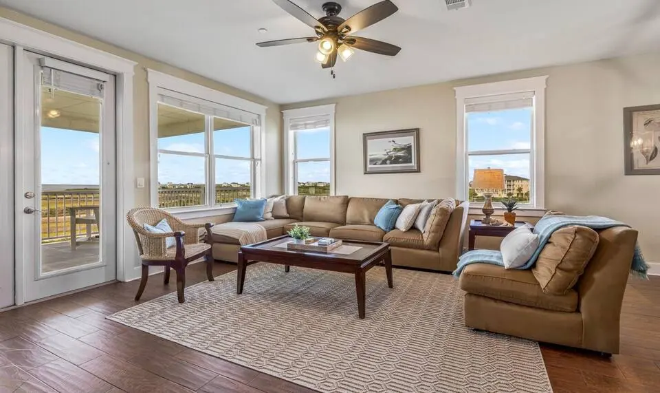 Living room with two sofas and wide windows at Top-Floor Condo at Pointe West