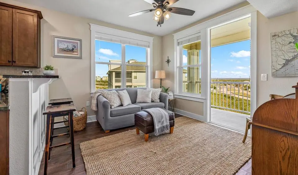 Sitting area with sofa and breakfast bar stools at Top-Floor Condo at Pointe West