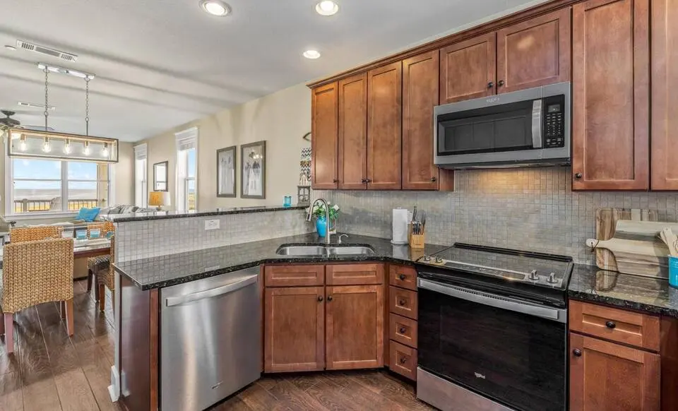 Full kitchen with granite counters and stainless appliances at Top-Floor Condo at Pointe West