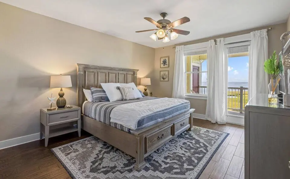 Bedroom with balcony access and water views at Top-Floor Condo at Pointe West