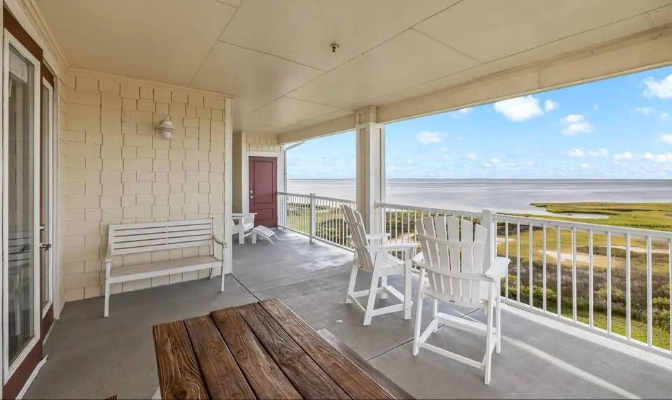 Covered balcony with rocking chairs at Top-Floor Condo at Pointe West