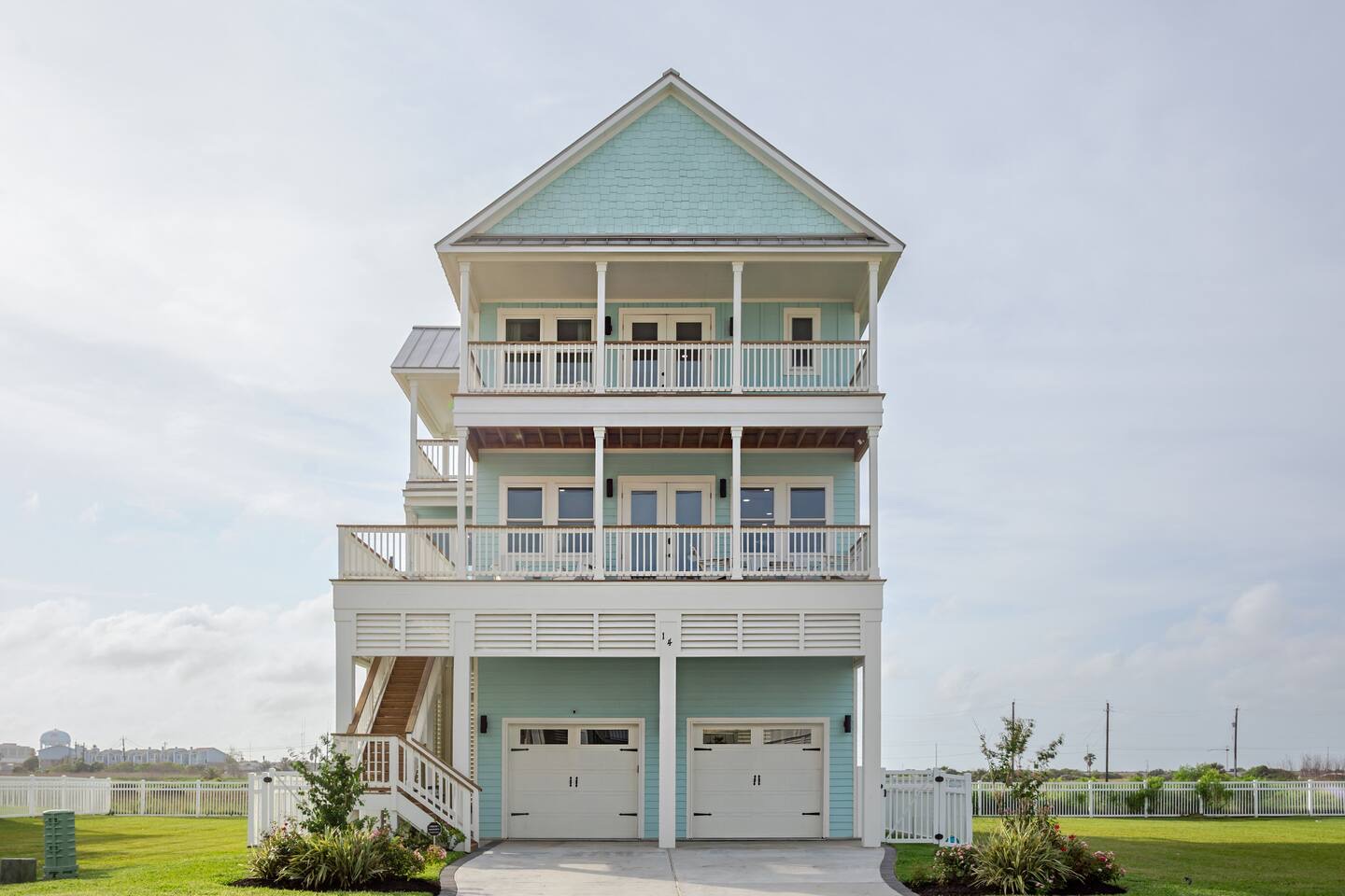 Alma de Mar vacation rental in Galveston — seafoam three-story beach house with stacked porches